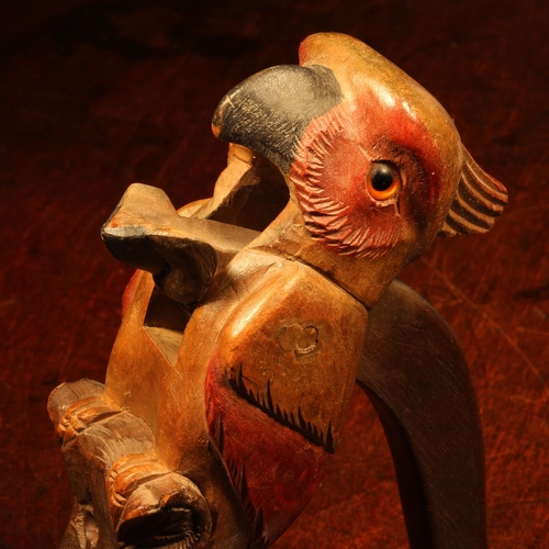 1061 - Nut Crackers - a Black Forest novelty lever-action nut cracker, carved as a parrot, glass eyes, pain... 