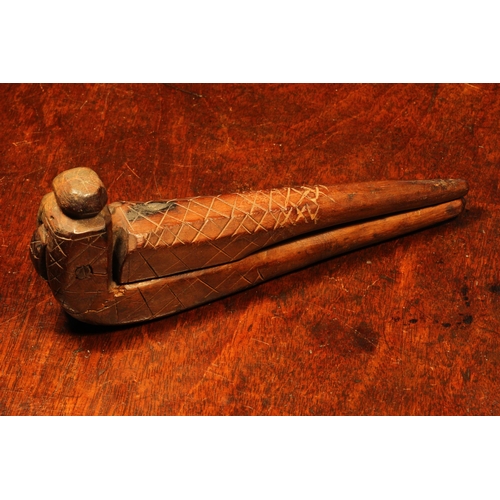 1133 - Nutcrackers - an 18th century fruitwood cross-over lever-action nut cracker, sgrafitto incised with ... 