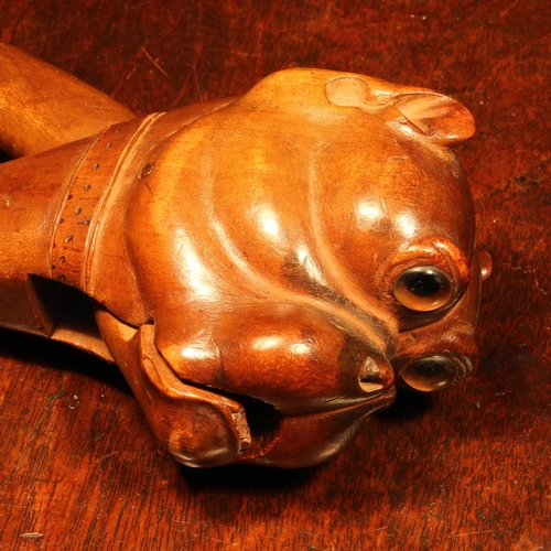 1075 - Nutcrackers - a Black Forest lever-action nut cracker, boldly carved as the head of a bulldog, glass... 