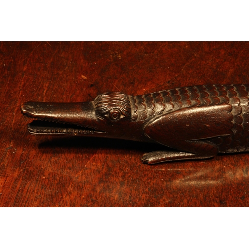 1155 - Nutcrackers - an early 19th century novelty screw-action nut cracker, carved as a crocodile, the tai... 