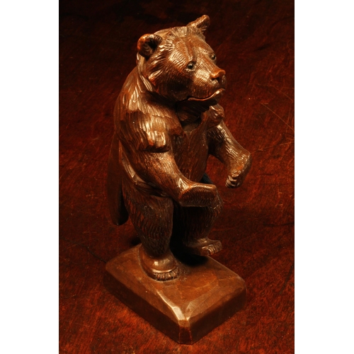 1109 - Nutcrackers - a Black Forest novelty table top lever-action nut cracker, carved as a bear, standing,... 