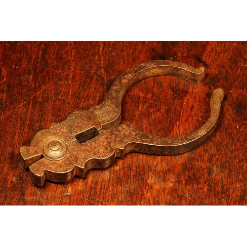 1145 - Nutcrackers - an early 18th century Spanish steel lever-action nut cracker, shaped jaws, 11cm long, ... 