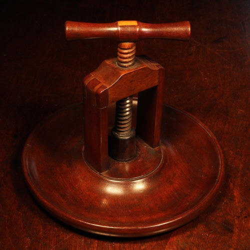 1072 - Nutcrackers - a 19th century mahogany table top screw-action nut cracker, corkscrew form handle, bro... 