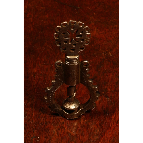 1067 - Nutcrackers - a 17th century steel scew-action nut cracker, the shaped thumbpiece drilled and pierce... 