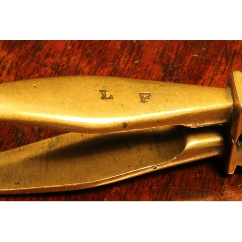 1159 - Nutcrackers - an unusual 18th century brass lever-action nut cracker, the jaws shaped and pierced in... 