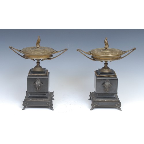 2104 - A pair of Art Nouveau bronze and belge noir marble covered urns, each with bird of prey finial, outs... 