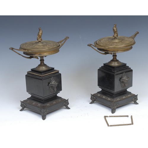 2104 - A pair of Art Nouveau bronze and belge noir marble covered urns, each with bird of prey finial, outs... 