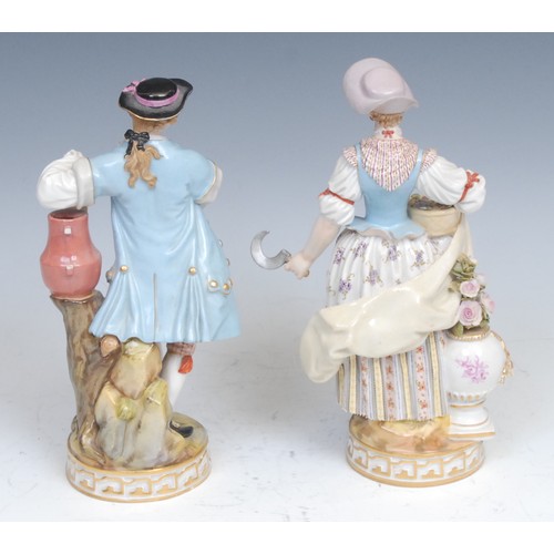 170 - A pair of Meissen figures, of a gardener and a flower lady, he with a spade and watering can, she wi... 