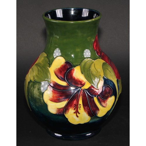 9 - A Moorcroft Hibiscus pattern ovoid vase, typically tubelined on a green ground, 25cm high, script si... 