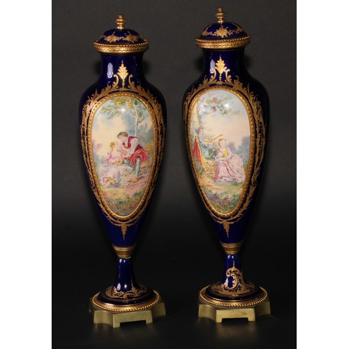 167 - A pair of French gilt metal mounted porcelain slender ovoid vases, painted in the manner of Sèvres w... 
