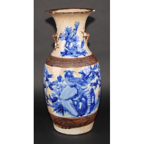 256 - A Chinese ovoid vase, painted in underglaze blue on a crackle glaze ground outlined in café au lait,... 