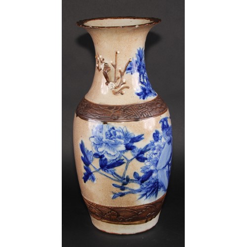 256 - A Chinese ovoid vase, painted in underglaze blue on a crackle glaze ground outlined in café au lait,... 