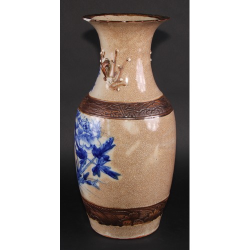 256 - A Chinese ovoid vase, painted in underglaze blue on a crackle glaze ground outlined in café au lait,... 