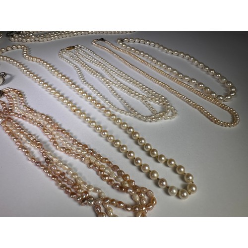 987 - A triple strand cultured pearl necklace; other cultured pearl necklaces and a ring (9)