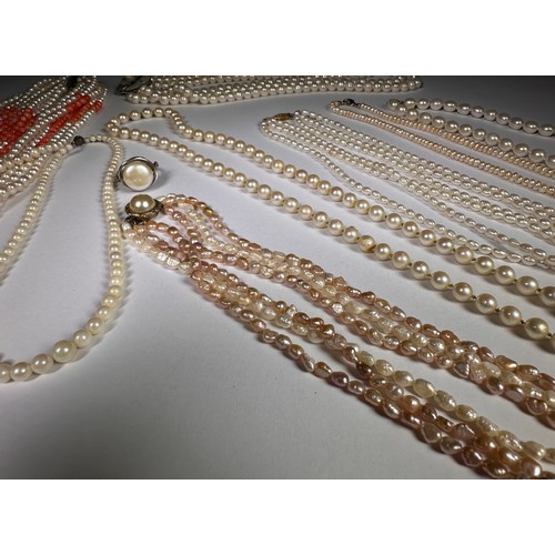 987 - A triple strand cultured pearl necklace; other cultured pearl necklaces and a ring (9)