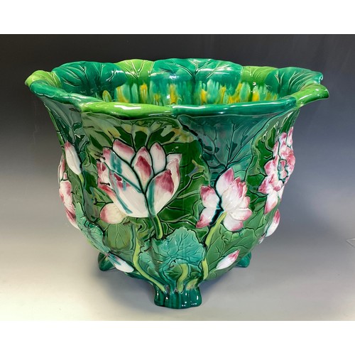 24 - A Minton majolica jardiniere, moulded with water lilies and glazed in tones of green, pink and yello... 
