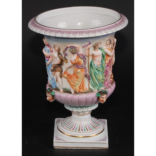 150 - A Naples porcelain campana shaped mantel urn, moulded in relief with classical figures dancing and p... 