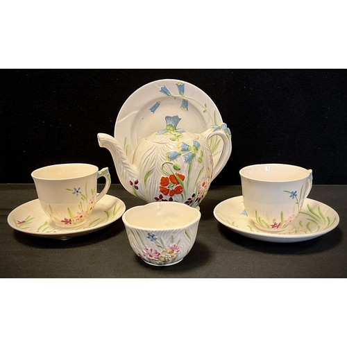 26 - A Beswick duet tea set, relief decorated in the Wayside floral design, c.1920 inc 871 shape teapot, ... 