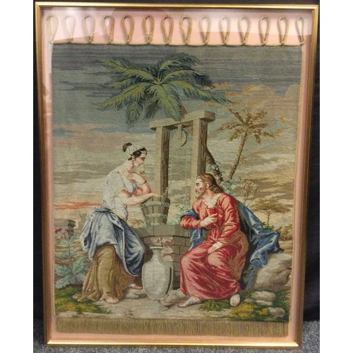 34 - A Victorian embroidered panel, Jesus and Mary at the Well, 118cm x 85cm framed