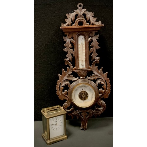 56 - A carved oak Barometer, 49cm long; Brass carriage clock (2)