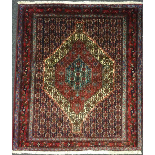 61 - A North West Persian Senneh rug / carpet, hand-knotted in rich tones of red, deep blue, turquoise, a... 