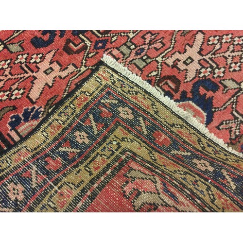 65 - A North West Persian Malayer rug / carpet, hand-knotted with a stylised floral field in red, deep bl... 