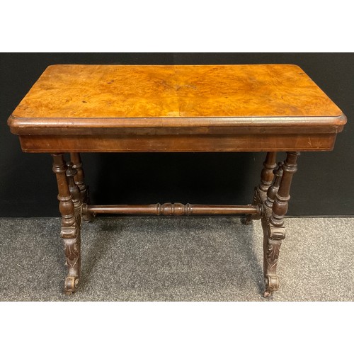 66 - A Victorian walnut and burr walnut card table, rounded rectangular top, turned supports, ceramic cas... 