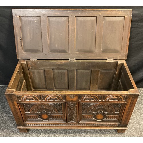 90 - An 18th century style carved oak coffee / blanket chest, four-panel hinged top, carved front, block ... 