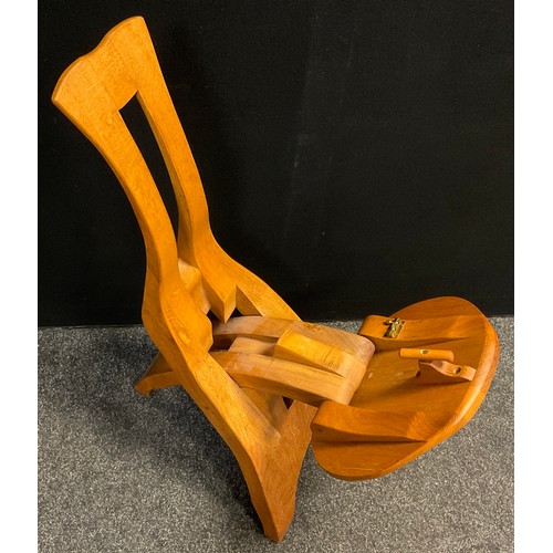 92 - A Brutalist style folding oak chair, in the manner of De Puydt, 90.5cm high x 41cm wide x 51cm deep ... 