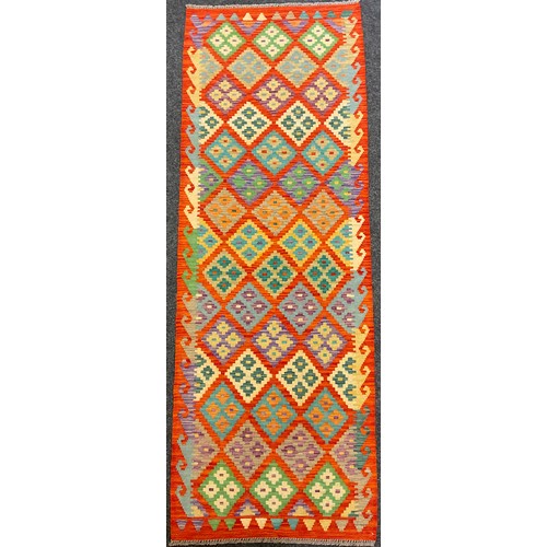 93 - A Turkish Anatolian Kilim rug / carpet, knotted in bright colours with a field of repeating diamonds... 