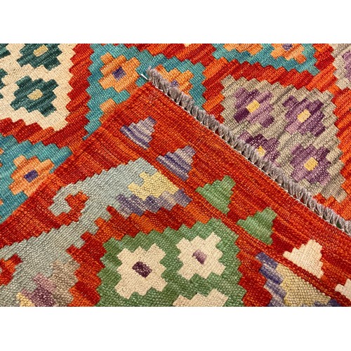 93 - A Turkish Anatolian Kilim rug / carpet, knotted in bright colours with a field of repeating diamonds... 