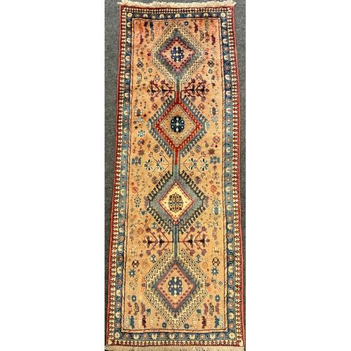 95 - A North West Persian Yallemeh runner carpet, knotted with a row of four diamond-shaped medallions, w... 