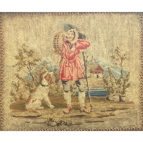 2130 - An 19th century woolwork picture, worked in coloured wools with a sportsman hunter alongside his hor... 