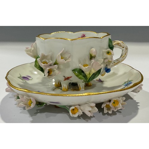 161 - A Meissen floral encrusted miniature teacup and saucer, painted with beetle, insects and blossom, gi... 