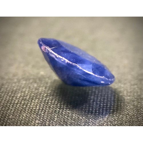 419 - Loose Gemstones- a large oval deep blue sapphire, weight approx 7.70ct, glass filled/treated.