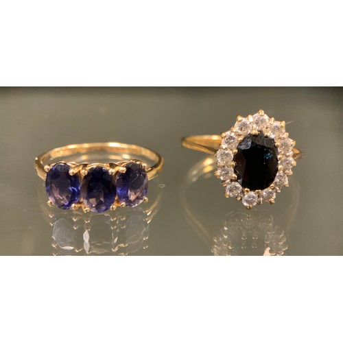 425 - A purply blue stoned trilogy ring, possibly tanzanite, 9ct gold shank, stamped 375 10k, TGGC, size P... 