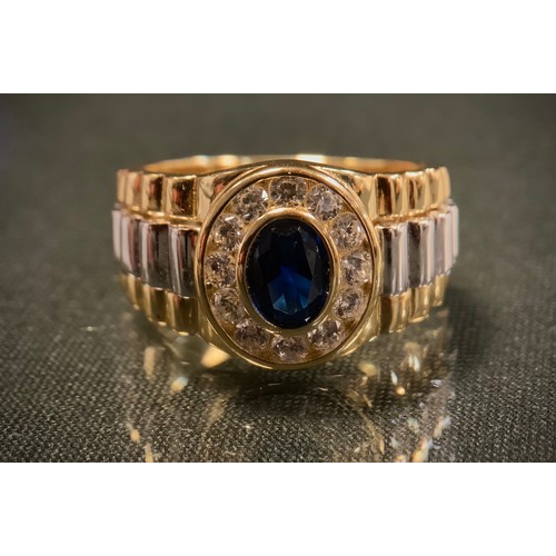 429 - A gold plated silver ring, in the Rolex style set with blue and white cubic zirconia, size P, 7.9g g... 