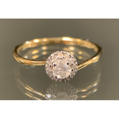 433 - A diamond ring, central round brilliant cut diamond approx 0.18ct, surrounded by a halo of smaller d... 