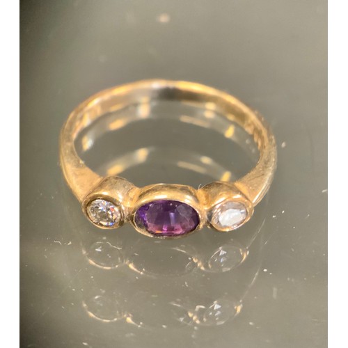 437 - A diamond and amethyst ring, central oval amethyst approx 0.15ct, set between round brilliant cut di... 