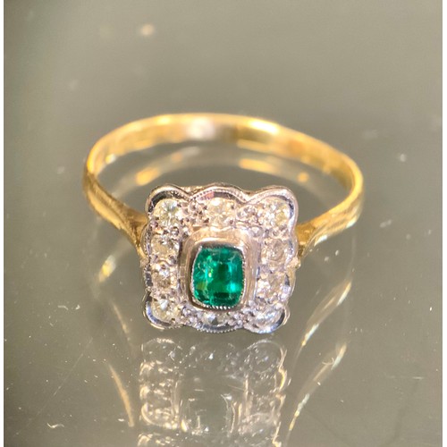 441 - An emerald and diamond ring, central emerald cut rectangular emerald approx 0.15ct,  surrounded by t... 