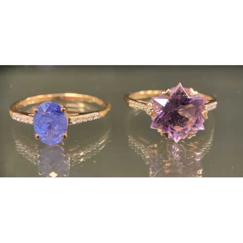 453 - A 9ct gold purply blue stoned possibly tanzanite and diamond ring, oval facet cut pale purply blue s... 