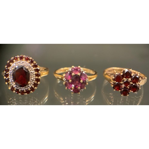 454 - A garnet and white stone oval cluster ring, (possibly Diamonds)  9ct gold shank, Birmingham 2007, si... 