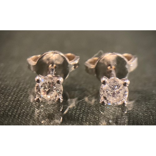 470 - A pair of certified diamond stud earring, each with a single round brilliant cut diamond, total diam... 