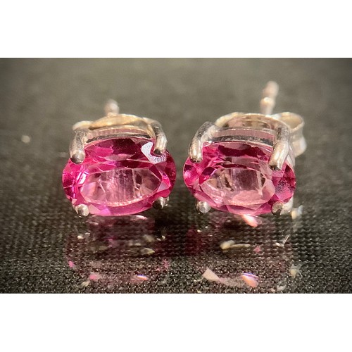 474 - A pair of oval pink topaz stud earrings, silver mounts, 1.8g gross.