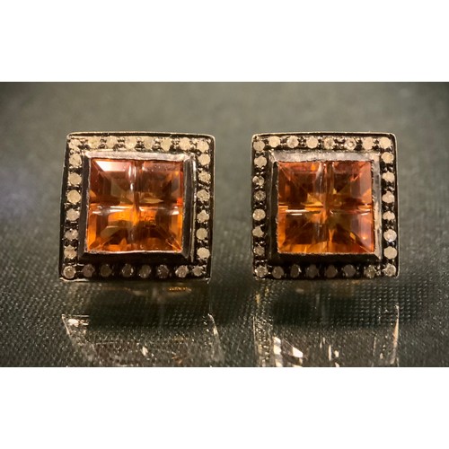 478 - A pair of citrine and rose cut diamond cufflinks, each with a square cross cut orange yellow citrine... 