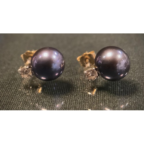 479A - A pair of diamond and south sea pearl earrings, each with a round brilliant cut diamond approx 0.13c... 