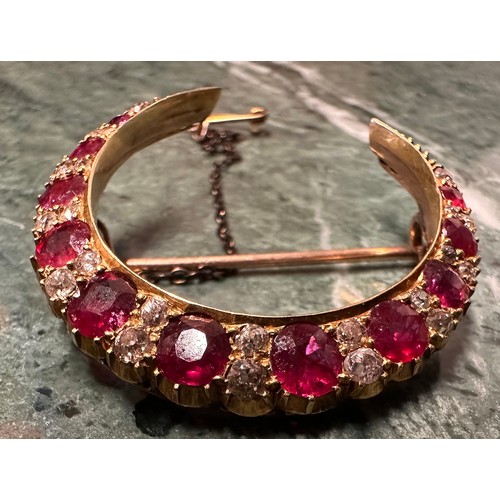 985A - A Victorian ruby and diamond crescent brooch, the 11 graduated round facet cut rubies divided by a p... 