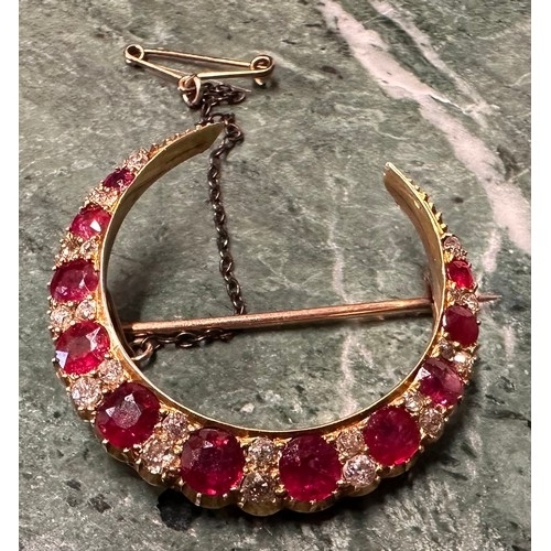 985A - A Victorian ruby and diamond crescent brooch, the 11 graduated round facet cut rubies divided by a p... 