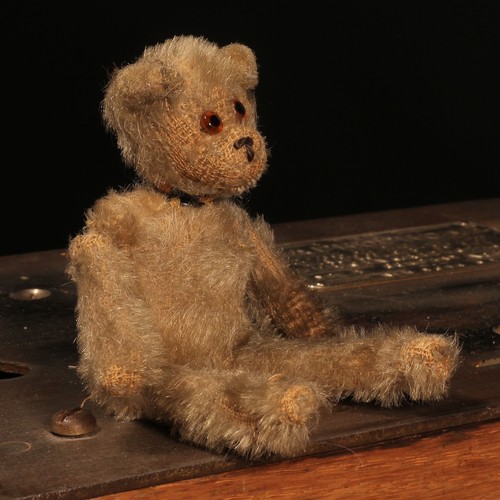 84 - An early 20th century jointed golden mohair miniature teddy bear, amber and black glass eyes, brown ... 