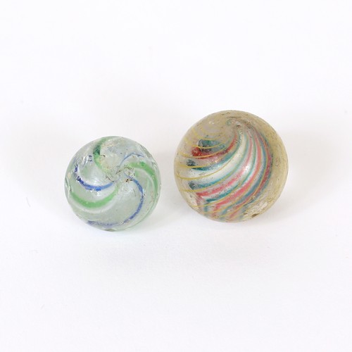 105 - Juvenalia - an early 20th century solid core swirl glass marble, the inner core section in red white... 